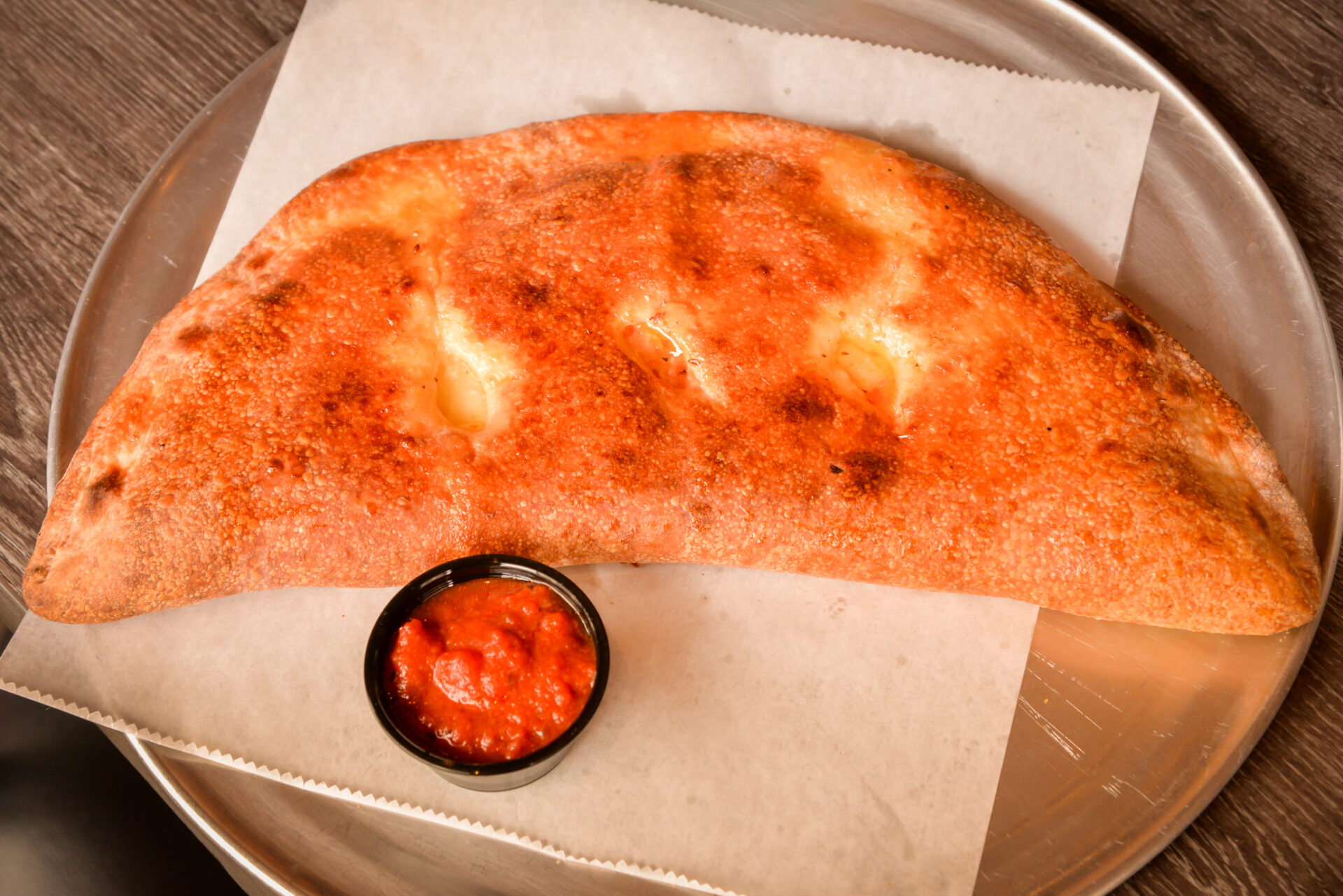 A large piece of bread on top of a pan.