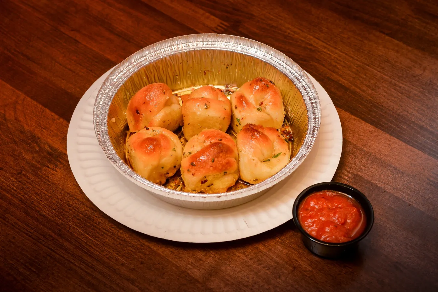 A bowl of bread and sauce on the table.