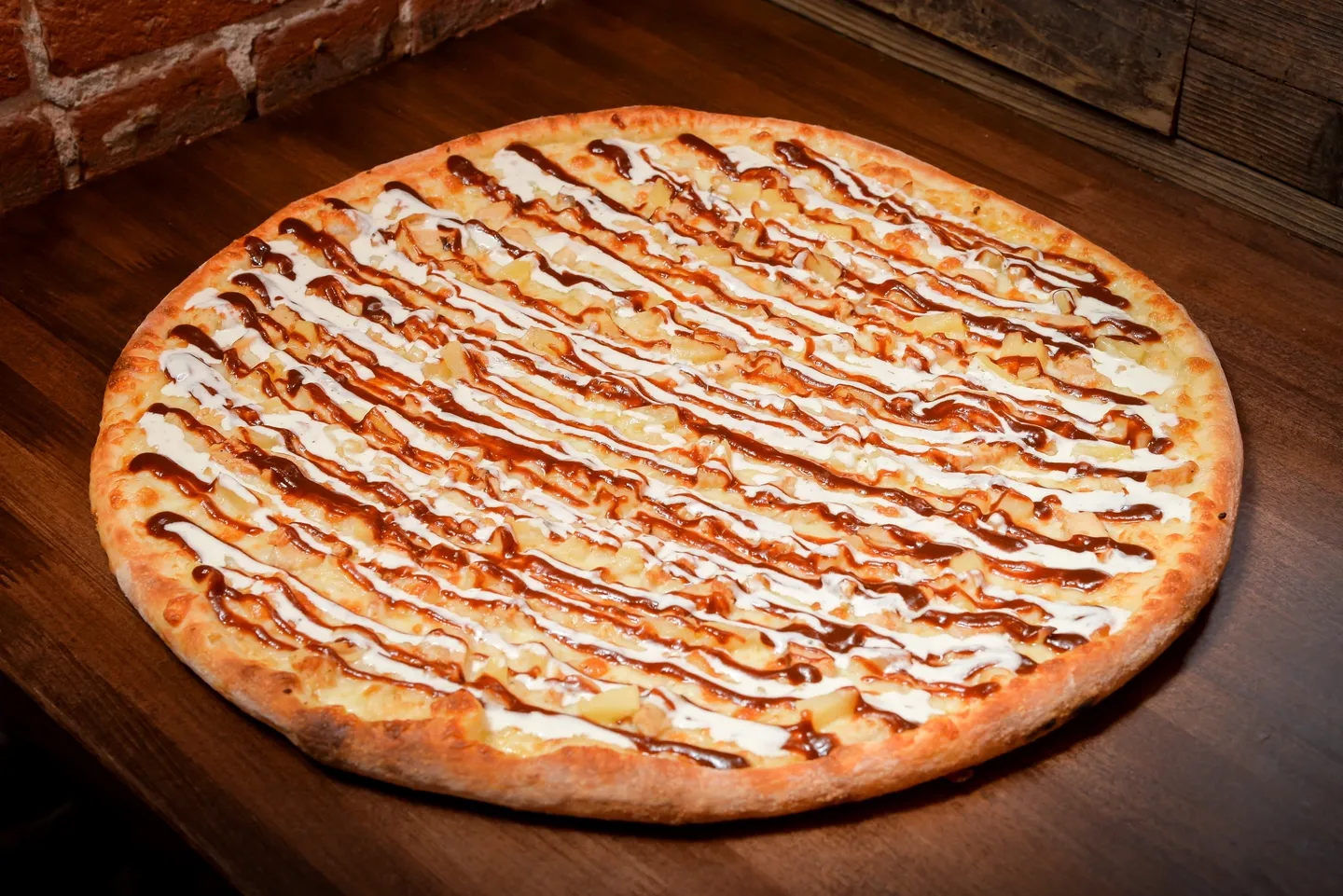 A pizza sitting on top of a wooden table.