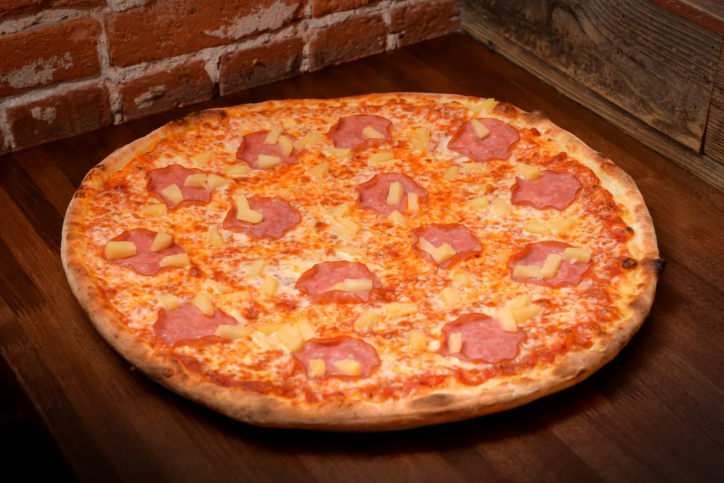 A pizza sitting on top of a wooden table.