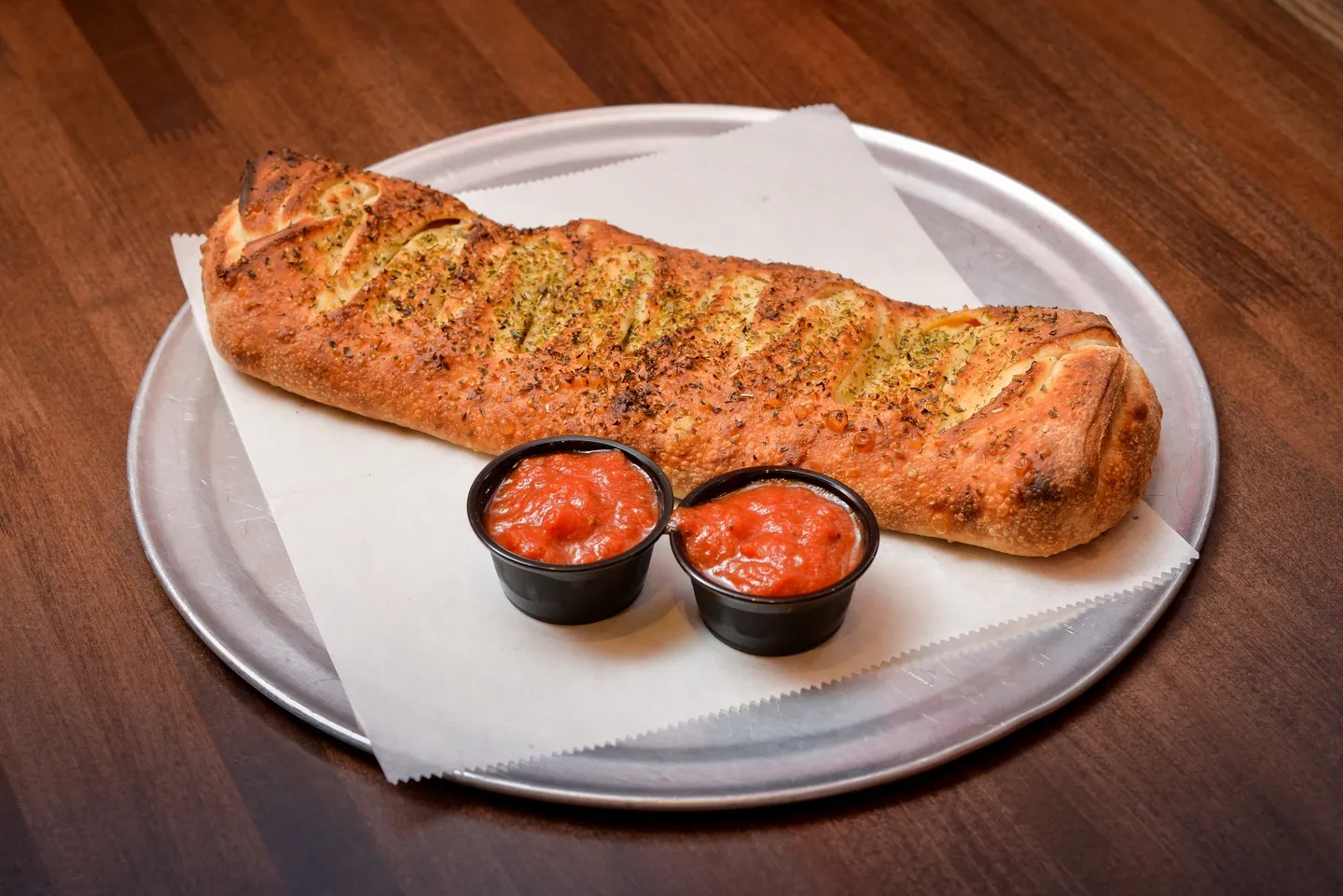 A long sandwich on top of a white plate.